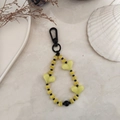 Detail of beaded heart keychain with striped patterns and black lobster clasp - Yellow and Black Heart Beaded Style (YS-A230012L)