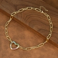 Detailed shot of golden paperclip chain necklace with a colorful zircon heart pendant - Rainbow Heart Style (NE2598-A)