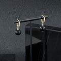 Détail de boucles d'oreilles dorées avec perles onyx noires et cristaux étincelants - Boucles d'Oreilles Agate Noire
