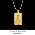 Macro shot of gold The Magician tarot card pendant with zircon inlay and box chain - Magician / Gold