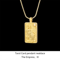 Macro detail of gold tarot Empress pendant with embossed figures and box chain necklace - The Empress / Gold