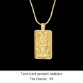 Macro shot of gold-plated Chariot tarot card pendant with diamond accent on box chain - The Chariot / Gold