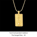 Detailed close-up of gold Solomon Tarot pendant featuring The Hanged Man with crystal stone - The Hanged Man / Gold