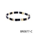 Macro detail of Bohemian geometric beaded bracelet with black and gold textured patterns - Black White Blue Ink Color Block Style (BR0877-C)