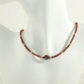 Detail view of handmade garnet beaded necklace with a red evil eye charm and gold spacers - Orange Garnet / Orange Garnet Style (NE1871)