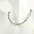 Detail of beaded necklace with evil eye charm and green stones on a neck mannequin - Ruby Zoisite / Ruby in Zoisite Style (NE1871)