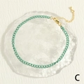 Close-up of mint green enamel anklet featuring a gold lobster clasp and extension chain - Mint Green
