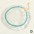 Detail of turquoise hip-hop anklet with gold lobster clasp and teardrop extension chain - Cyan