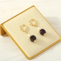 Dettaglio orecchino a cerchio in oro 18K con perla bianca e pietra viola sfaccettata - Viola Ametista