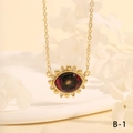Macro shot of vintage Turkish eye pendant with deep red stone and gold plating detail - Dark Red Starry Sunflower Style (NE2265-B-1)