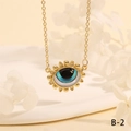 Macro shot of gold Turkish evil eye pendant necklace with blue enamel and crystal inlay - Classic Blue Eye Sunflower Style (NE2265-B-2)