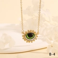Macro view of gold evil eye pendant necklace with green center and sunburst rays - Realistic Green Eye Sunflower Style (NE2265-B-4)