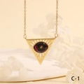 Macro detail of gold triangle necklace with black opal stone and sunburst engraving - Black Opal Triangle Style (NE2265-C-1)