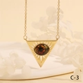 Detail shot of golden triangular evil eye pendant with radial hollow rays and brown stone - Starry Blue Triangle Style (NE2265-C-2)