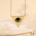 Detailed macro view of gold triangle evil eye pendant on white flowers backdrop - Red Brown Starry Triangle Style (NE2265-C-3)