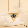 Detail of a golden triangle pendant with a blue evil eye motif on a thin link chain - Wavy Blue Triangle Style (NE2265-C-6)