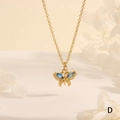 Macro shot of gold butterfly pendant featuring marquise blue zircon and grainy texture - Blue Zirconia (NE2275-D)