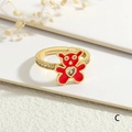 Close-up of gold bear ring with red enamel and heart-shaped zircon stones - Adjustable Open / Red Bear Style (RG0745-C)