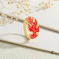 Close-up of golden monstera leaf ring with vibrant red enamel on a white display stand - Adjustable Open / Red Style (RG0721-C)