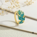 Close-up of golden monstera leaf open ring with sky blue enamel details and boho style - Adjustable Open / Sky Blue Style (RG0721-H)