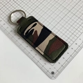 Detail showing camouflage canvas keychain lipstick pouch on a white measurement grid - Army Green Camo