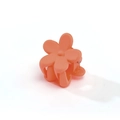 Close-up of matte orange-red flower hair claw clip with smooth frosted plastic petals - Hot Pink