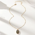 Elegant gold necklace featuring an oval purple amethyst pendant with golden star designs - A7467-5