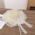 Beige straw sun hat with blue ribbon bow and delicate white lace brim detail - Blue Ribbon Beige
