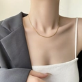 Minimalist golden snake bone chain necklace worn by a model as a chic clavicle accessory - 45+5cm / Gold