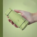 Lightweight six-fold capsule umbrella in matcha green being held by a single hand - Flat 6-Fold Ordinary Black Glue / With Cloth Sleeve / Matcha Green
