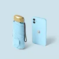 Sky Blue ultra-light mini flat umbrella shown alongside a smartphone for size scale - Flat 5-Fold / With Cloth Sleeve / Sky Blue