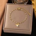 Elegant gold titanium steel bracelet featuring white pearl and shell charms - Pearl Shell Bracelet (E2267) / Gold