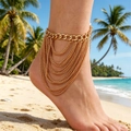 Tobillera de cadena dorada de varias capas estilo bohemio usada en la playa tropical soleada - Tobillera de Borlas Multicapa Extendida (WG-1357)