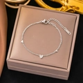 Polished silver titanium steel chain bracelet featuring three dainty heart charms - Triple Heart Bracelet Steel (SLE32)