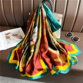 Silk-textured long scarf with green and orange floral print draped on a handbag - Green and Red Contrast Lotus (XL87-2) / 180x90cm