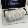 Floral cotton pencil case with blue flowers on cream base placed on a laptop keyboard - Light Blue Floral Pencil Case