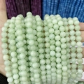 Close-up of polished light green chalcedony round beads for DIY jewelry making - A442 Chalcedony - Green Angel Stone
