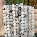Detail of natural tourmalinated quartz round beads showing black needle inclusions - A50 Chalcedony - Black Rutilated Quartz