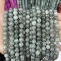Close-up of polished round chalcedony beads in various grey and natural stone textures - A13 Chalcedony - Emerald Green
