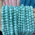 Macro shot of natural blue Amazonite stone beads for DIY jewelry and beaded necklaces - A55 Chalcedony - Ice Cyan Amazonite
