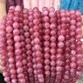 Close-up of pink chalcedony round beads with natural texture for DIY jewelry - A579 Chalcedony - Strawberry Quartz