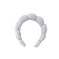 Close-up of white braided sponge headband featuring soft plush fabric and voluminous texture - White