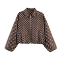 Close-up of dark brown jacket with white polka dots featuring a silver zipper closure - Brown Polka Dot