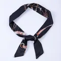 Elegant narrow black twilly scarf featuring a sophisticated gold chain and harness print - X48