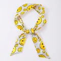 Elegant narrow silk scarf featuring a cheerful yellow smiley face print and grid pattern - X72