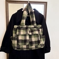 Winter plush tote bag featuring green and black plaid pattern with front pockets - Green