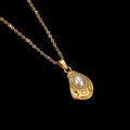 Macro detail of tear-shaped gold pendant with pearl center and fine beaded texture - Teardrop Pearl Pendant (CYN010)