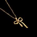 Detailed close-up of golden bow pendant with white pearl on minimalist beaded chain - Minimalist Streamlined Bowknot Pendant (CYN010-2)