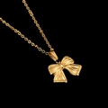 Close-up of golden bow pendant necklace with radiant texture on black background - Radial Texture Bowknot Pendant (CYN010-3)