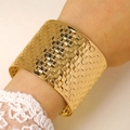 Detail of wide gold cuff bracelet featuring embossed geometric grid and mirror finish - Woven Check Embossed Bangle (2442) / Gold